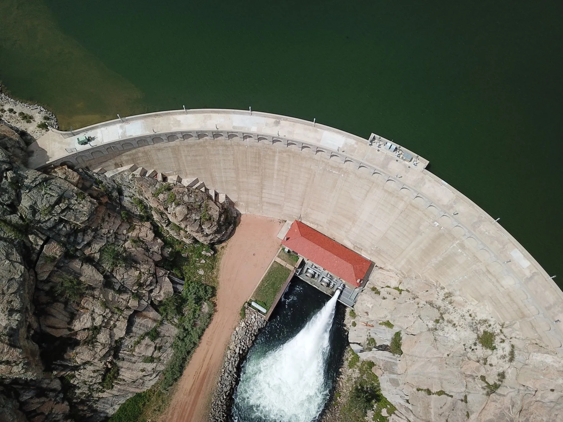 Hydroelectric dam and spillway within a natural environment